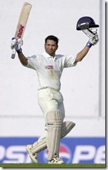Indian ace batsman Sachin Tendulkar raises his bat and helmet to acknowledge the cheering crowd after scoring a double century on th