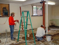 Henry Myers and Randy Gingerich cut out parts of the cement floor.  Photo Courtesy:  Iowa Mennonite School