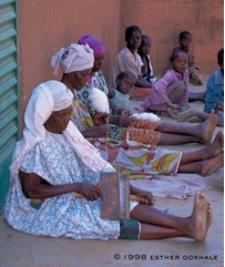 Women in Burkina Faso sit on the floor spinning cotton and suffer no pain.