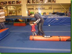 Daddy helping Emily on the balance beam.