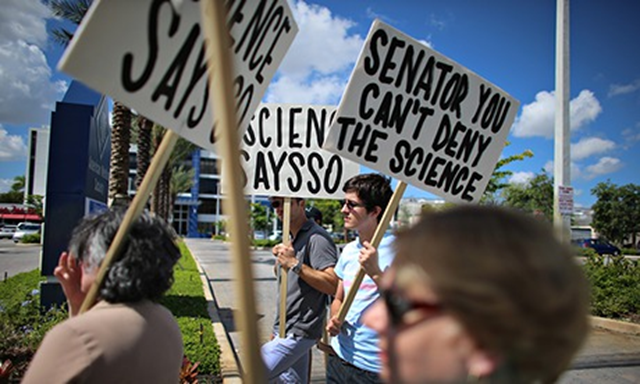 Protesters gather near the office of Senator Marco Rubio to ask him to take action to address climate change. Photo: Joe Raedle / Getty Images