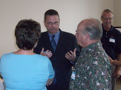 City Administrator candidate James Bowden speaks with Mayor Sandra Johnson and Bob Shepherd at a meet and greet at the Washington Public Library.