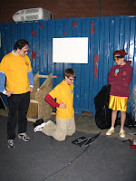 A mentor helps students program the robot
