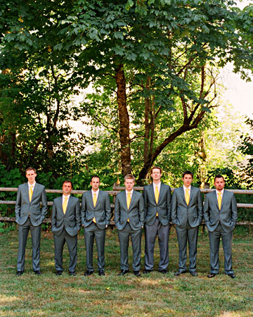Groom Scott and his groomsmen donned gray suits and sunny yellow ties made to match the design of the couple's invitation suite. Groom Scott and his groomsmen donned gray suits and sunny yellow ties made to match the design of the couple's invitation suite.