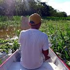 Sun brightly shines at mid-day as Herman navigates our way through the marsh in our boat.