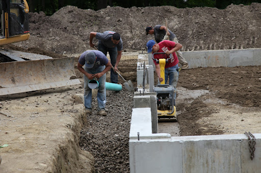The whole process will take a few weeks.  They've already graded the site and poured the cement footing and foundation.