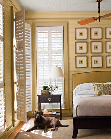 In this master bedroom, a ceiling fan with mahogany blades and tongue-and-groove wood paneling convey a cottage feel. In this master bedroom, a ceiling fan with mahogany blades and tongue-and-groove wood paneling convey a cottage feel.