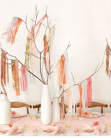These simple fringe pieces are draped over branches and set in a clean, white vase for a more modern bridal shower table. (marthastewartweddings.com) These simple fringe pieces are draped over branches and set in a clean, white vase for a more modern bridal shower table. (marthastewartweddings.com)