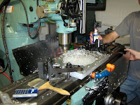 A student lubricates the CNC machine