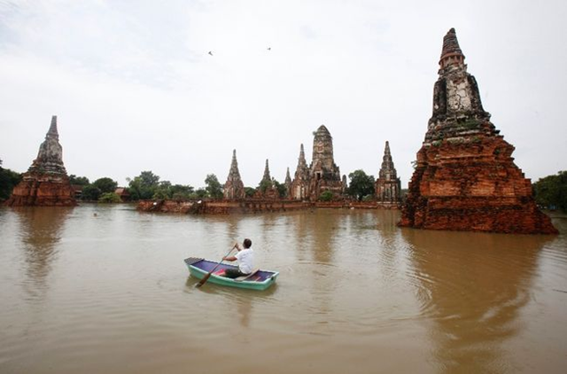 A media member paddles his boat at a flooded temple at Wat Chaiwatthanaram, a UNESCO World Heritage Site, in Ayutthaya province, nearly 80 km (50 miles) north of Bangkok October 4, 2011. Chaiwat Subprasom / REUTERS