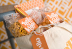 The tote contains Goldfish crackers, colored pencils, a notepad and more. Patterned tape and labels keep the bags neat and sealed.