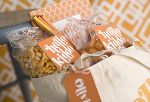 The tote contains Goldfish crackers, colored pencils, a notepad and more. Patterned tape and labels keep the bags neat and sealed.