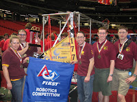 Mentors pose with robot