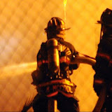 A fire, possibly caused by electrical failure, ripped through several homes under redevelopment. The center structure was well involved when firefighters arrived and was already catching the homes on either side on fire. Flying embers also caught nearby fields on fire. No one was injured in the blaze. News_110711_StructureFire_IrisAve