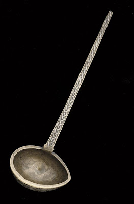 Ladle | Origin:  Iran or Afghanistan | Period: 12th-13th century | Details:  Not Available | Type: Bronze, inlaid with silver and black organic material | Size: H: 18.0  W: 5.7   D: 2.6  cm | Museum Code: F1992.57 | Photograph and description taken from Freer and the Sackler (Smithsonian) Museums.