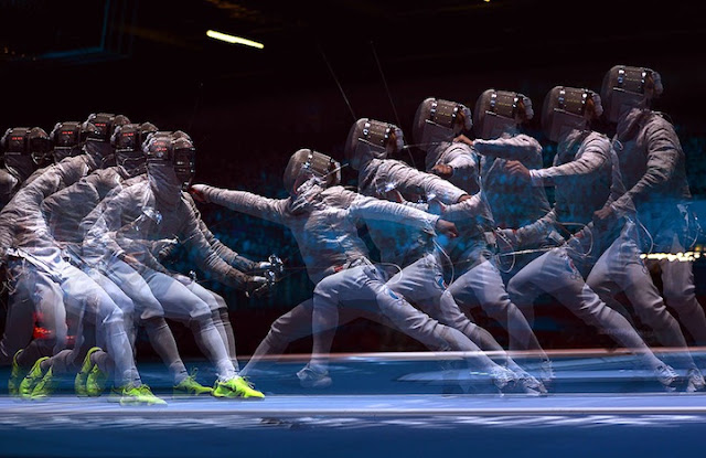 A multiple exposure picture taken at the ExCel centre in London shows fencer fighting during a Men's Sabre fencing bout as part of the London 2012 Olympic games.