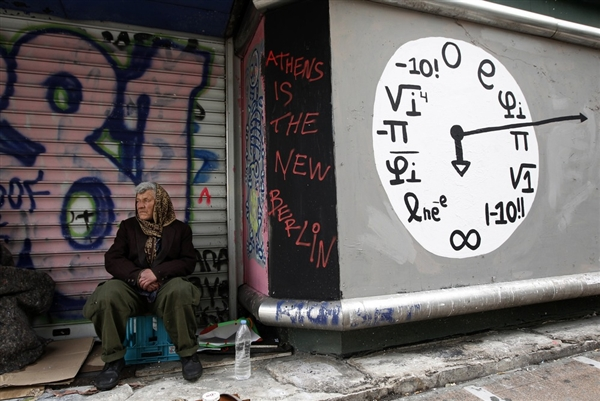 A shoe shine man sits in front of a closed shop in central Athens Wednesday, 8 February 2012. Keith Miller / worldblog.msnbc.msn.com