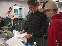 A mentor reviewing a student's designs