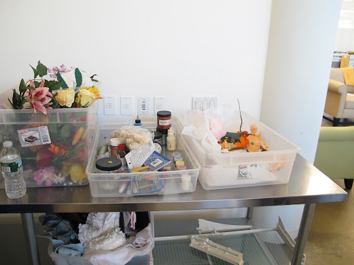 Crafting supplies and decorative flowers are in abundance.