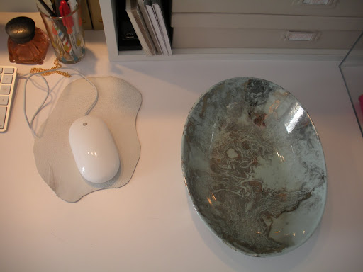 I cut a piece of leather to make a small blotter that acts as a chic mouse pad. The marbleized, metallic bowl was found at a flea market in Pennsylvania.
