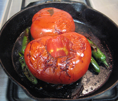 Time to remove the serranos and start peeling the tomatoes.