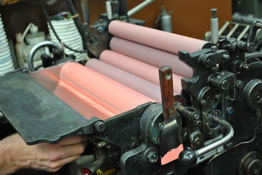 Here the ink is being rolled through -- I love all of the pinks in this shot!