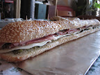For an appetizer, I made muffaletta sliders by slicing down a whole loaf of semolina bread filled with olive salad, provolone cheese, mortadella, and salami.