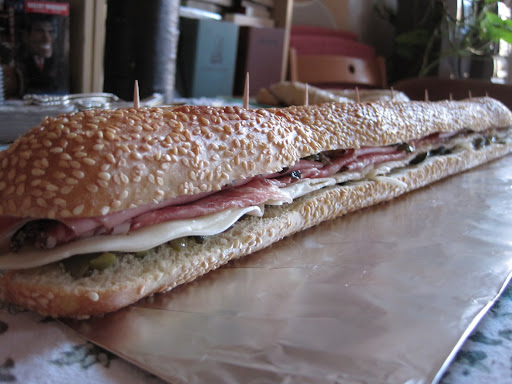 For an appetizer, I made muffaletta sliders by slicing down a whole loaf of semolina bread filled with olive salad, provolone cheese, mortadella, and salami.