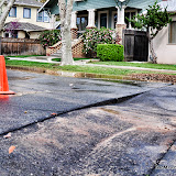 According to a resident of the effected street, water came up and onto the street from under the pavement for about an hour. The pavement where the water was coming from looked displaced, and sunken. City crews arrived to handle the situation. The displaced area of pavement looked like it had some kind of work done prior. Water was rushing quickly onto U and V Streets. No other damage or injury seemed apparent.
Road closure signs were posted at both ends of 28th. News_120322_Flood28&U