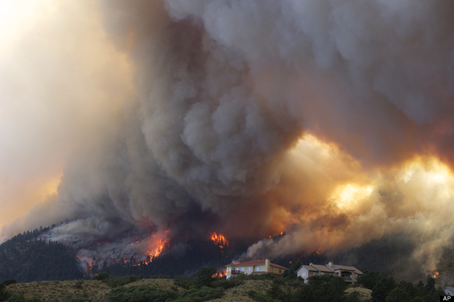 Fire from the Waldo Canyon wildfire burns as it moved into subdivisions and destroyed homes in Colorado Springs, Colo., on Tuesday, 26 June 2012. Gaylon Wampler / AP Photo