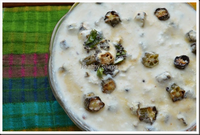 Bowl of chilled pachadi flecked with crisp okra