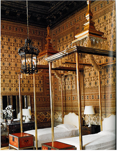 India cotton printed walls are the perfect backdrop for these four-poster beds adorned with capricious details, such as tassels.