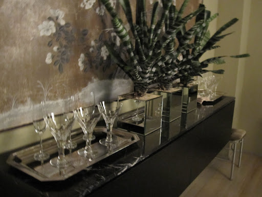 Extra glasses are placed behind the dining room table -- in a location that is easy to get to if someone needs something during dinner.