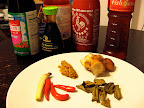 Some of the ingredients we used: hot and sweet chili sauce, a dark soy sauce, fish and regular soy sauce. On the plate (clockwise from left): small red chiles, lemongrass, our homemade curry paste, galangal, and dried kaffir lime leaves.