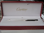This silver pen is by Cartier and is called the Santos de Cartier. It's screw motif is as classic as the jeweler's love bracelet.