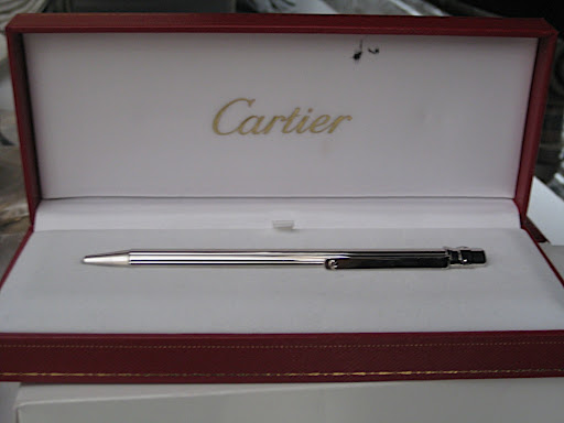 This silver pen is by Cartier and is called the Santos de Cartier. It's screw motif is as classic as the jeweler's love bracelet.
