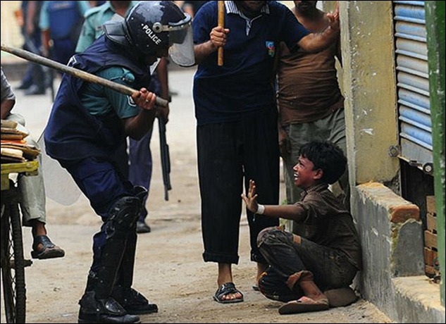 Police assault on child worker striking western clothing factory for wages and conditions, Bangladesh, 2011.
