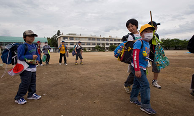 Children walk across the playground at Oyama primary school, which is located 40 miles from the Fukushima Daiichi nuclear power plant. Robert Gilhooly /  guardian.co.uk