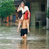 A man carries his wife through a flooded street in Xianning, Hubei province July 15, 2010. Central China faces its worst flooding since 1998 when thousands died, as rain continues to batter the upper and middle reaches of the Yangtze River, a state newspaper said on Thursday. Picture taken July 15, 2010. REUTERS/Stringer (CHINA - Tags: DISASTER ENVIRONMENT IMAGES OF THE DAY) CHINA OUT. NO COMMERCIAL OR EDITORIAL SALES IN CHINA for01170753p1.jpg