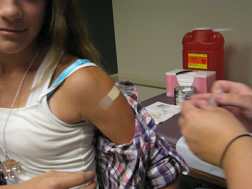 Quick and virtually painless, the girl receives a bandaid after her vaccination. Photo credit: Marrie Yvonne Ochieng