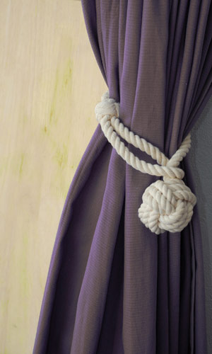 Hold curtains in their place with this unique monkey-fist knot rope tieback. (stairropes.com) Hold curtains in their place with this unique monkey-fist knot rope tieback. (stairropes.com)
