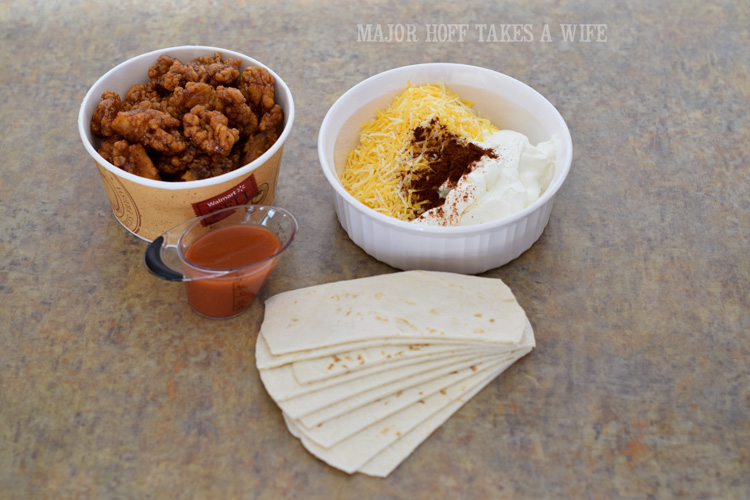 Use prepared wings to make easy hot wing enchiladas. Need a quick recipe for your next tailgate? Look no further than already prepared Deli Hot wings by Tyson. Make quick hot wing tortilla roll ups if you are in a hurry, or take the time to make Tex Mex Hot Wing Enchiladas. Great for a last minute dinner too! #GameTimeHero #CollectiveBias #recipe #ad Use prepared wings to make easy hot wing enchiladas