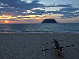 A beautiful sunset picture with an outrigger canoe in the foreground, looking across the bay to Nosy Ankarea (the other little island) in the background. Madagascar6 - 081b.jpg