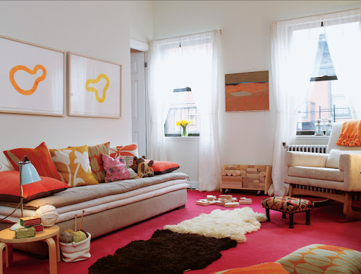 I love a long, low sofa in the living room.  The bold colors and patterns of the pillows look great with the neutral tones.  The side table is actually a stool that was cut to work with the height of the sofa.  So smart!