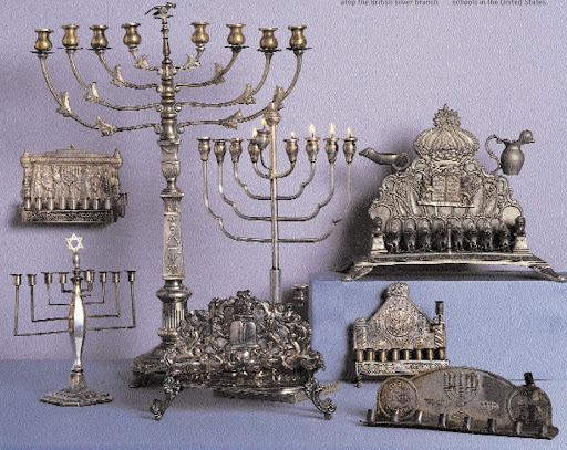 Most of these pieces are silver plated - at times, European Jews were kept from owning solid silver, but silver plate often escaped confiscation. The wall-hunt example (middle left) was made in 1920 at the Israeli arts school Bezalel. The Star of David atop the British silver branch menorah (bottom, far left), 1929, is also a snuffer. Most of these pieces are silver plated - at times, European Jews were kept from owning solid silver, but silver plate often escaped confiscation. The wall-hunt example (middle left) was made in 1920 at the Israeli arts school Bezalel. The Star of David atop the British silver branch menorah (bottom, far left), 1929, is also a snuffer.
