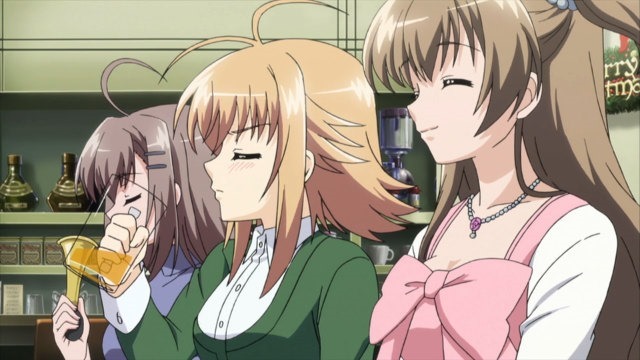 Three girls sit at a table in a restaurant, one smiling, one drinking beer angrily, and one exasperated holding a party horn.