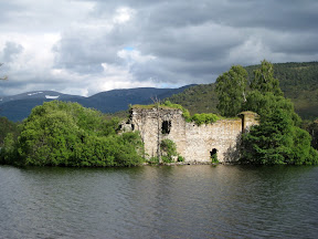 a castle surrounded by a lake just before aviemore