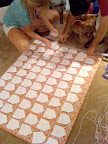 Here my sister and Craig are placing the envelopes on the pin-board. We pinned yarn down first in a grid so that we'd know where each envelope would go, then made sure they were alphabetized before pinning them in place.