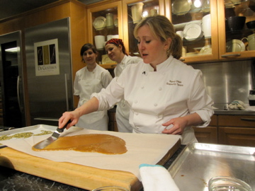 Next, Nancy and her kitchen crew made her chocolate-covered toffee. After the toffee turned a beautiful caramel color, Nancy and her chef assistants pulled it off of the heat and spread it out onto a buttered sheet of parchment paper. Next, Nancy and her kitchen crew made her chocolate-covered toffee. After the toffee turned a beautiful caramel color, Nancy and her chef assistants pulled it off of the heat and spread it out onto a buttered sheet of parchment paper.