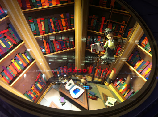 The librarian in this window moves back and forth on her ladder while Virginia is below reading a book.